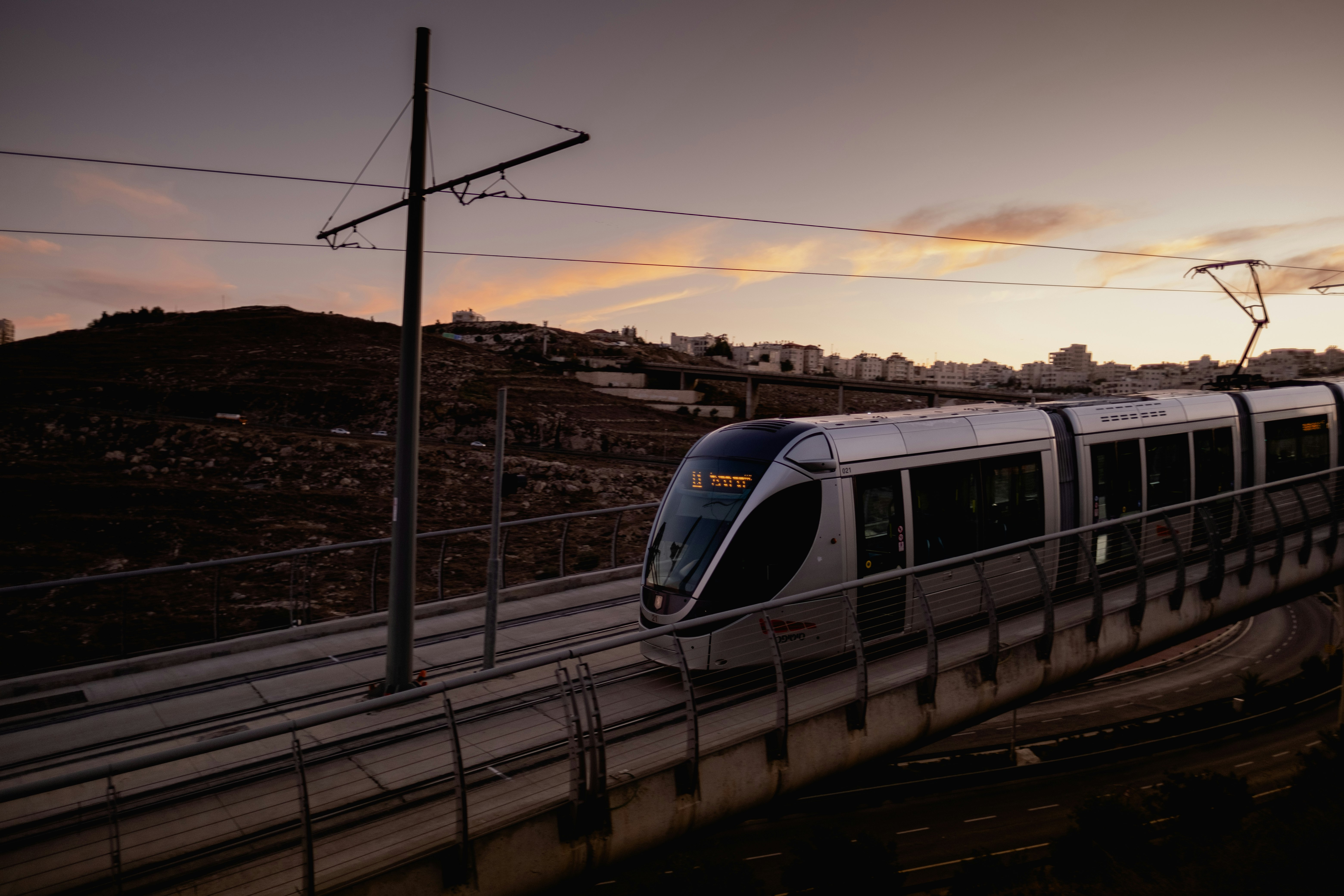 white and blue train on rail during daytime